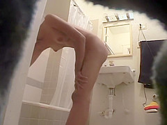 Slender girl rubs lotion on her hot body