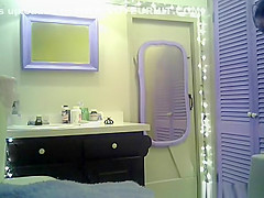 Small boobs chick with purple hair undressing in bathroom