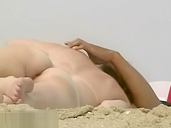 Superb beach video of a trimmed pussy tanning