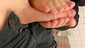 Swedish girl gives footjob in a public restroom