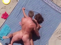 Tanned couple has an amazing sex on the beach