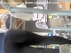 Tattooed woman running in treadmill