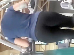 Tattooed woman running in treadmill