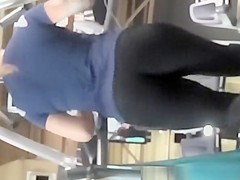 Tattooed woman running in treadmill