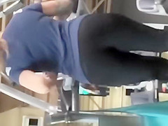Tattooed woman running in treadmill