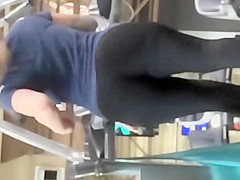 Tattooed woman running in treadmill