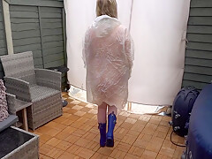 Under Plastic Transparent Raincoat And Wellingtons Out In The Cold Outdoors