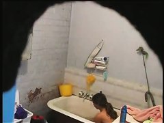 brunette girl gets nude and takes a quick bath in a shower porno