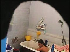 brunette girl gets nude and takes a quick bath in a shower porno